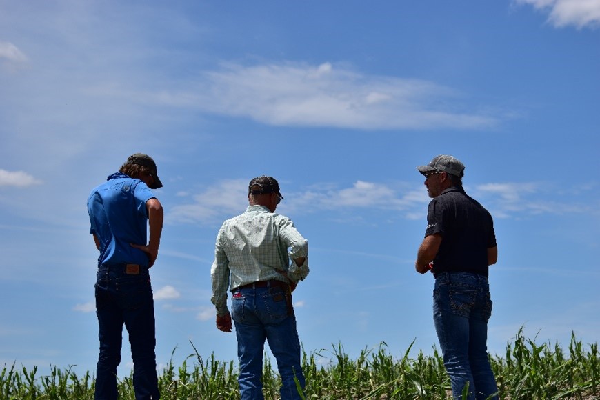 Craig Langemeier and Stacey Stewart talking to a customer about what to do next after the hailstorm came through the area. 